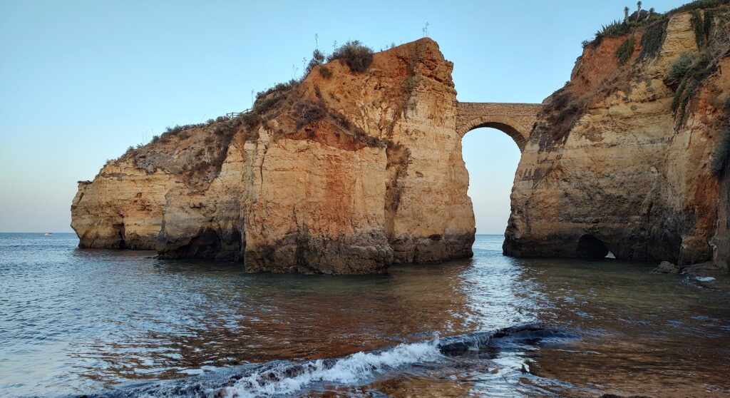 Rock arch across the water, Portugal, 2024